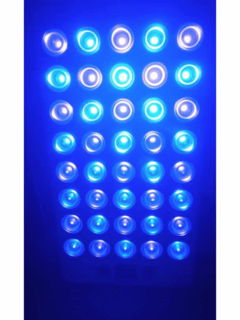 White CHIRYO light therapy panel switched on, emitting a bright blue glow from 20 circular LED lenses.