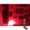 SLEEP red light rechargeable Lamp turned on showing bendy gooseneck positioning red illumination in lounge with photo frames on the wall. 270 lumens, no blue light RECHARGEABLE BATTERY POWERED LAMP DIMMING bendy GOOSENECK black