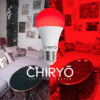 sleep red light bulb E27 switched on in living room, before and after split image shows natural daylight showing sofa cushions and wall art in one half and after SLEEP red light bulbs E27 healthy lighting blue light free light bulbs CHIRYO LIGHT THERAPY