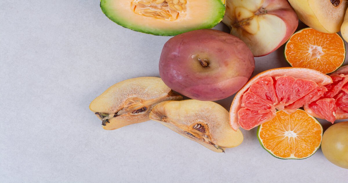 assortment-of-discoloured-fresh-fruits-white-table. assortment-of-discoloured-fresh-fruits-white-table.