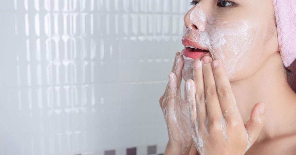 Ointments and Skincare wisdom article blog how to maximise the benefits of LED Light Therapy CHIRYO Light Therapy washing face looking into bathroom mirror